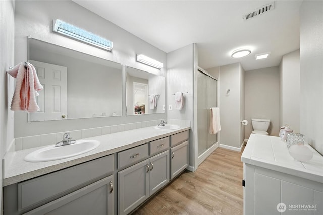 2322 Garrison St, Walla Walla, WA 99362 - full bathroom with double vanity, a stall shower, and wood finished floors