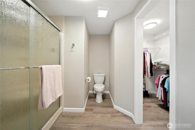 2322 Garrison St, Walla Walla, WA 99362 - bathroom featuring wood finished floors, a spacious closet, and a shower stall