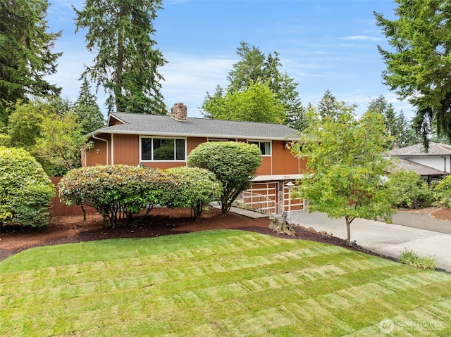 7523 13th Ave SE, Lacey, WA 98503 - single story home with concrete driveway, a front yard, a chimney, and roof with shingles