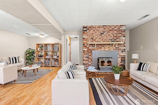 7523 13th Ave SE, Lacey, WA 98503 - living room featuring wood finished floors and a brick fireplace