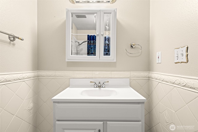7523 13th Ave SE, Lacey, WA 98503 - bathroom featuring tile walls, vanity, and wainscoting