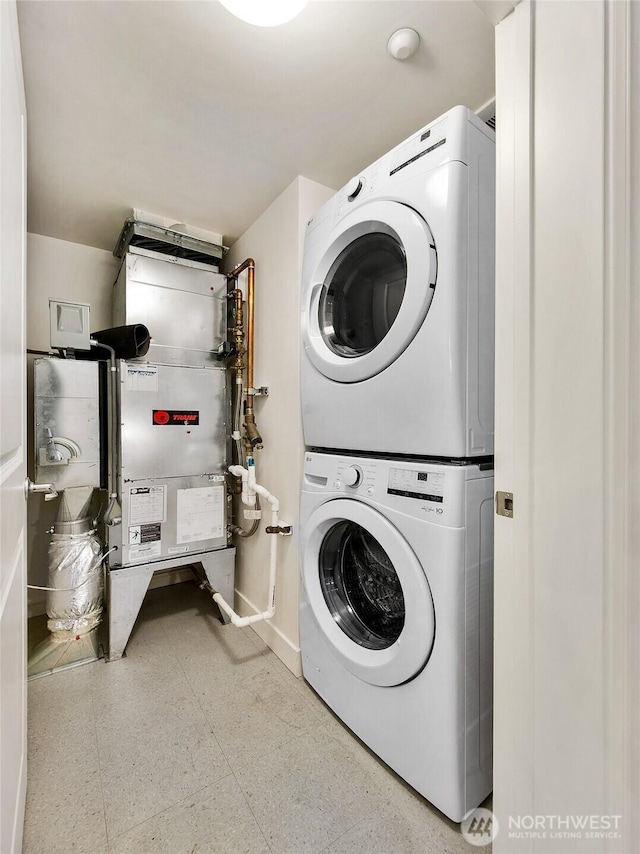 819 Virginia St Unit 1606, Seattle, WA 98101 - laundry room featuring estacked washer and dryer and baseboards
