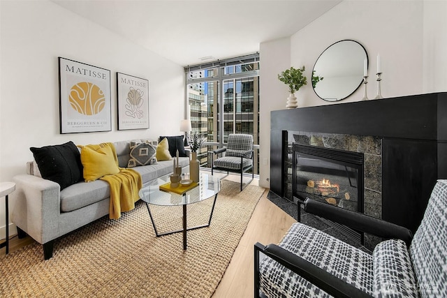 819 Virginia St Unit 1606, Seattle, WA 98101 - living area featuring light wood-style flooring, a wall of windows, and a tiled fireplace