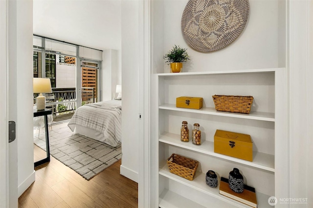 819 Virginia St Unit 1606, Seattle, WA 98101 - bedroom with access to exterior, wood finished floors, and floor to ceiling windows