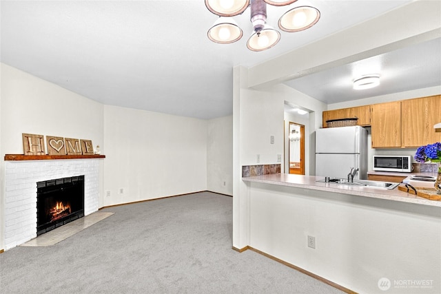 17521 118th Ave SE Unit A-4, Renton, WA 98058 - kitchen with white appliances, carpet flooring, a fireplace, and light countertops