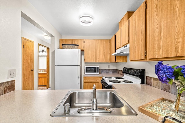 17521 118th Ave SE Unit A-4, Renton, WA 98058 - kitchen with white appliances, under cabinet range hood, and light countertops