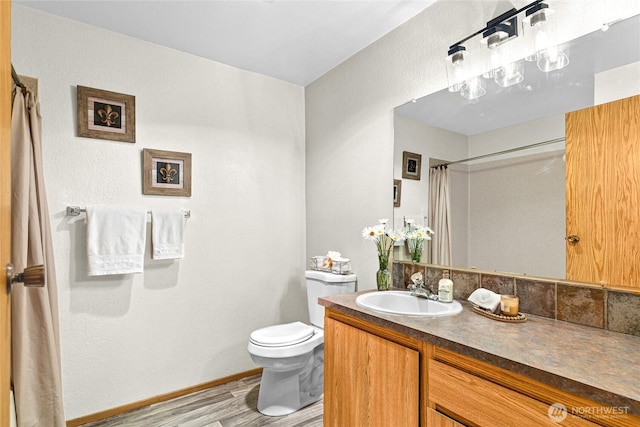 17521 118th Ave SE Unit A-4, Renton, WA 98058 - bathroom with wood finished floors, vanity, curtained shower, and decorative backsplash
