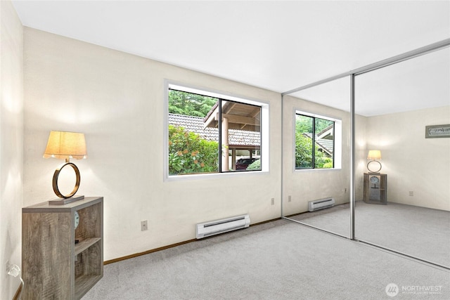 17521 118th Ave SE Unit A-4, Renton, WA 98058 - unfurnished bedroom featuring a baseboard radiator, carpet flooring, and multiple windows
