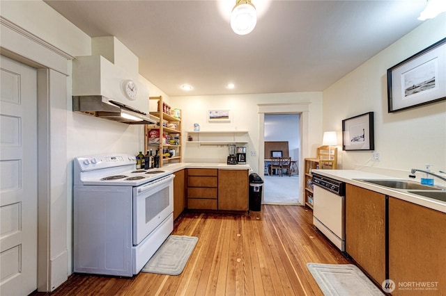 231 E 1st St, Port Angeles, WA 98362 - kitchen with white appliances, light wood-style flooring, light countertops, under cabinet range hood, and brown cabinets