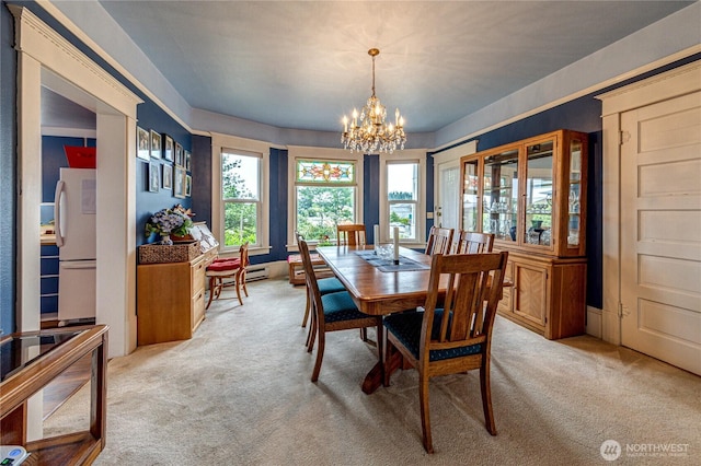 231 E 1st St, Port Angeles, WA 98362 - dining area featuring light colored carpet, a chandelier, and healthy amount of natural light