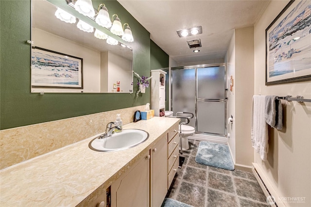 231 E 1st St, Port Angeles, WA 98362 - bathroom with vanity, a baseboard radiator, and a shower stall