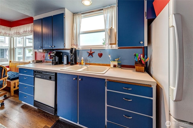 231 E 1st St, Port Angeles, WA 98362 - kitchen featuring blue cabinets, white appliances, light countertops, and dark wood-style flooring