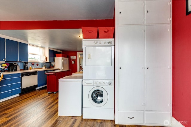 231 E 1st St, Port Angeles, WA 98362 - washroom with stacked washer / drying machine and dark wood-type flooring