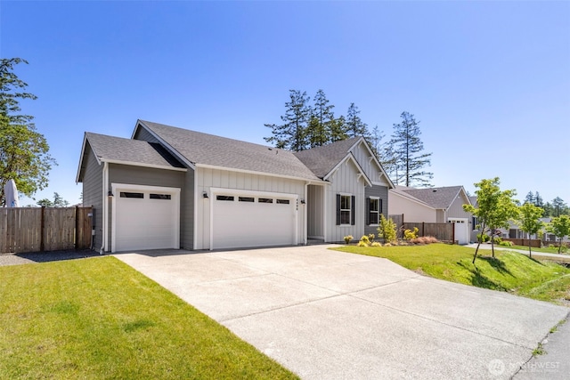 4490 Albatross St, Port Townsend, WA 98368 - view of front facade featuring board and batten siding, a garage, concrete driveway, and a shingled roof