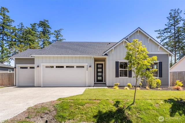 4490 Albatross St, Port Townsend, WA 98368 - view of front of home with a garage, concrete driveway, board and batten siding, and roof with shingles