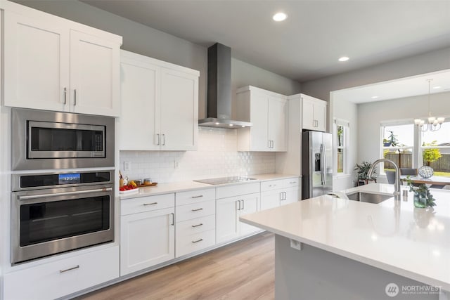4490 Albatross St, Port Townsend, WA 98368 - kitchen featuring stainless steel appliances, wall chimney exhaust hood, light countertops, recessed lighting, and tasteful backsplash