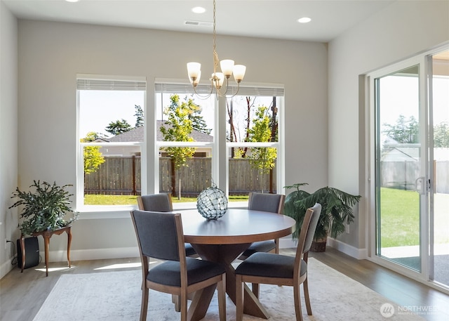 4490 Albatross St, Port Townsend, WA 98368 - dining area with a chandelier, plenty of natural light, wood finished floors, and recessed lighting