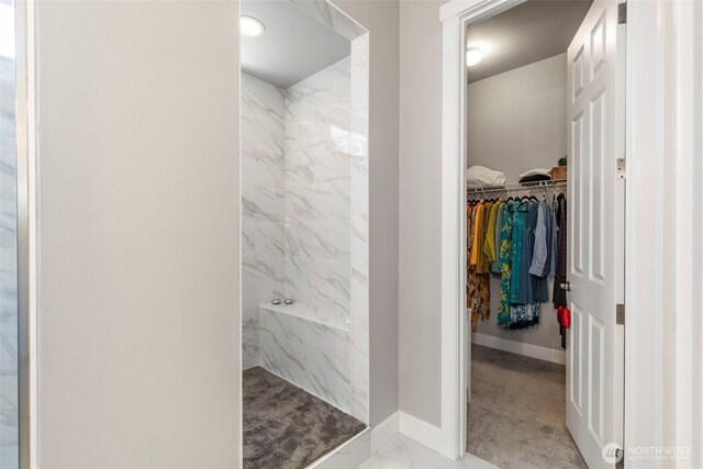 4490 Albatross St, Port Townsend, WA 98368 - full bathroom featuring a marble finish shower, a walk in closet, and marble look tile flooring