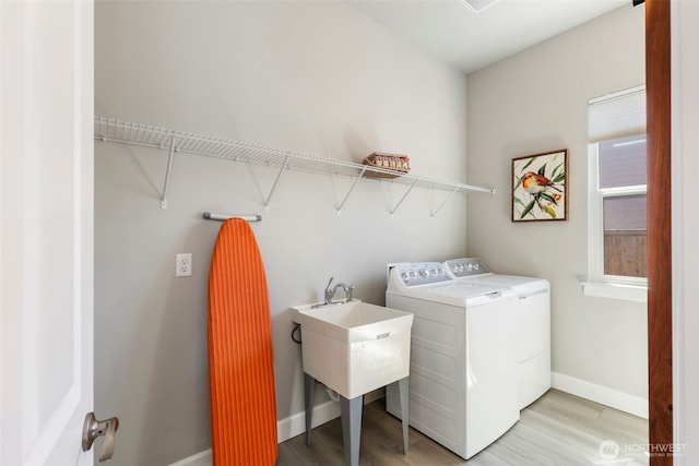 4490 Albatross St, Port Townsend, WA 98368 - laundry area with washer and clothes dryer and light wood-style floors