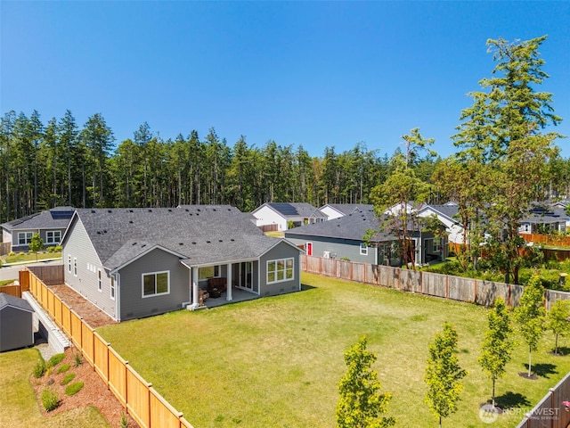 4490 Albatross St, Port Townsend, WA 98368 - rear view of house featuring a fenced backyard, a patio, a shingled roof, and a residential view