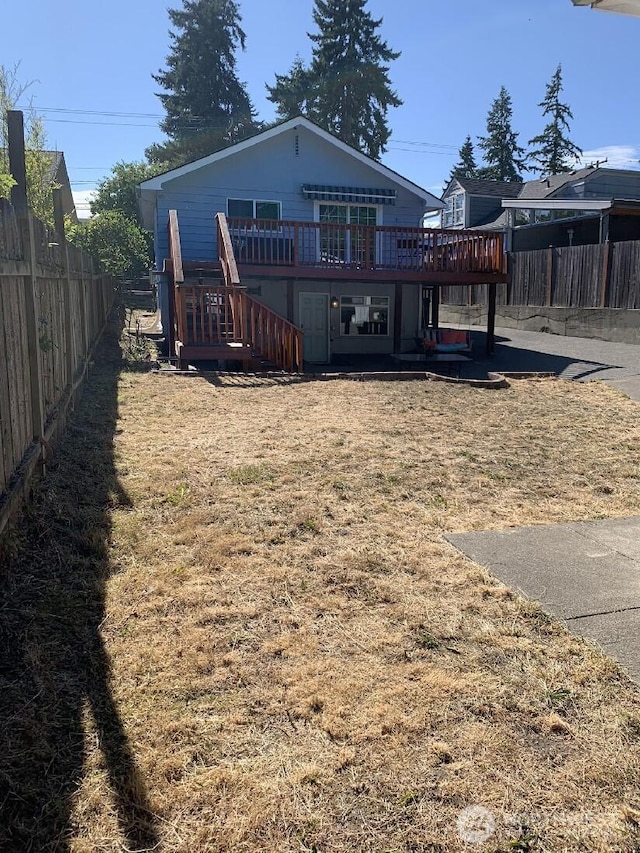 5910 21st Ave SW, Seattle, WA 98106 - back of property with a wooden deck, a fenced backyard, and stairway