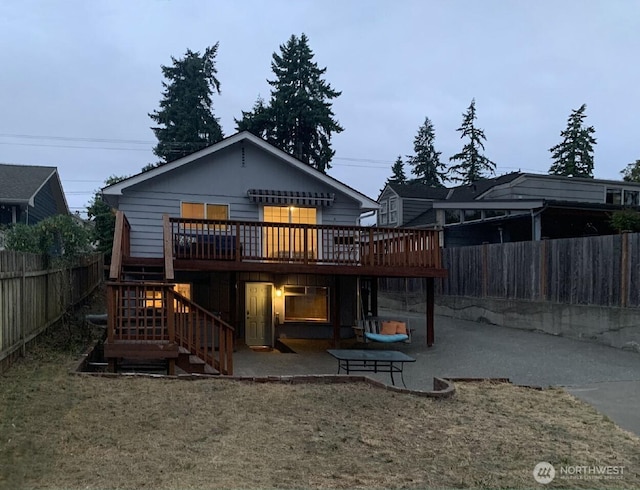 5910 21st Ave SW, Seattle, WA 98106 - rear view of house featuring a deck, a patio, a fenced backyard, and stairs