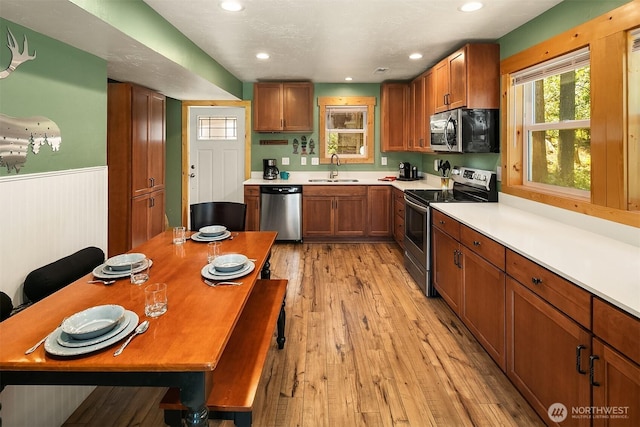 61 Tom And Nita Rd, Cle Elum, WA 98922 - kitchen with appliances with stainless steel finishes, healthy amount of natural light, a wainscoted wall, brown cabinets, and recessed lighting