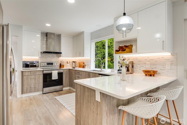 36318 30th Ave S, Federal Way, WA 98003 - kitchen with stainless steel appliances, wall chimney range hood, modern cabinets, a peninsula, and recessed lighting