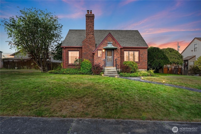 235 S 59th St, Tacoma, WA 98408 - tudor-style house featuring brick siding and a chimney