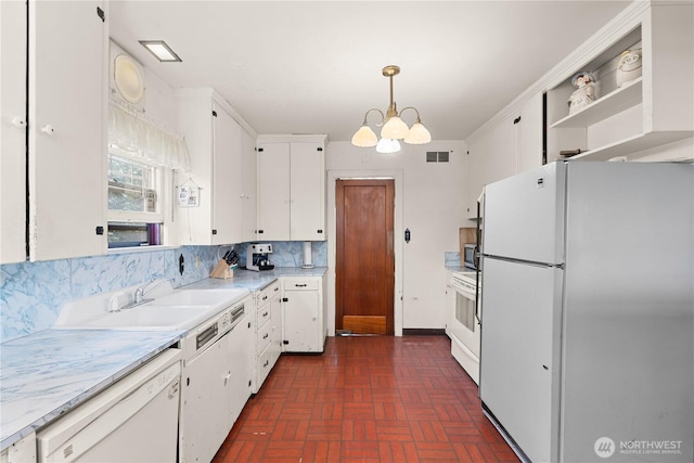 235 S 59th St, Tacoma, WA 98408 - kitchen featuring white appliances, brick patterned flooring, a chandelier, white cabinets, and light countertops