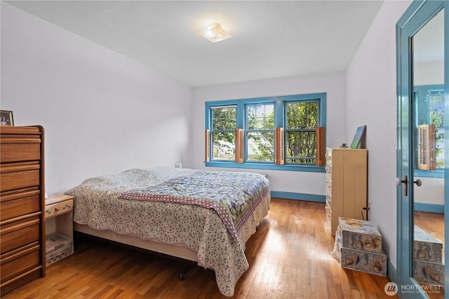 235 S 59th St, Tacoma, WA 98408 - bedroom featuring wood-type flooring and baseboards