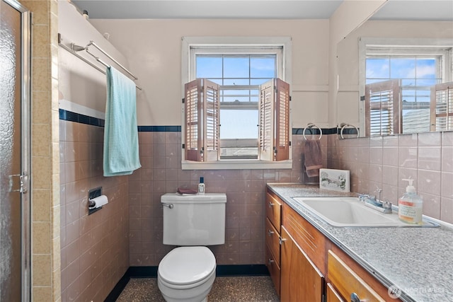 235 S 59th St, Tacoma, WA 98408 - full bathroom with tile walls, vanity, and a wainscoted wall