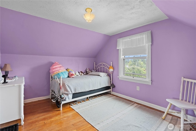 235 S 59th St, Tacoma, WA 98408 - bedroom with vaulted ceiling, hardwood / wood-style flooring, and a textured ceiling