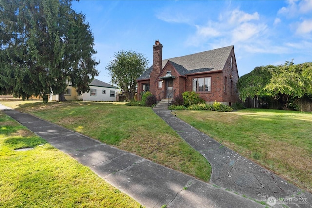 235 S 59th St, Tacoma, WA 98408 - view of front facade featuring brick siding, a front yard, and a chimney