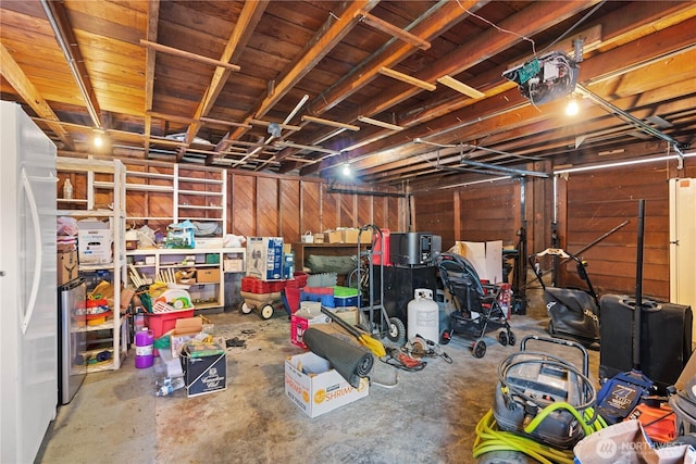 235 S 59th St, Tacoma, WA 98408 - unfinished basement featuring wooden walls and freestanding refrigerator