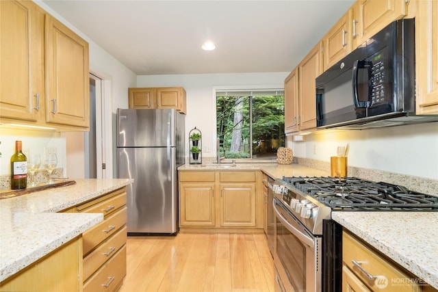 22526 53rd Ave SE, Bothell, WA 98021 - kitchen with stainless steel appliances, light wood-style flooring, light stone countertops, light brown cabinets, and recessed lighting