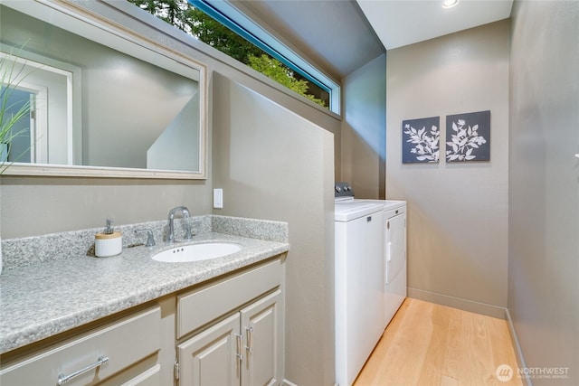 22526 53rd Ave SE, Bothell, WA 98021 - bathroom featuring washer and dryer, wood finished floors, and vanity