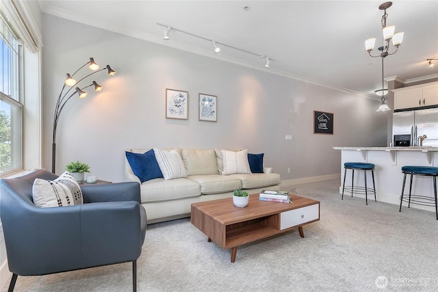 1000 High St Unit 102, Bellingham, WA 98225 - living area featuring light carpet, ornamental molding, track lighting, and a chandelier