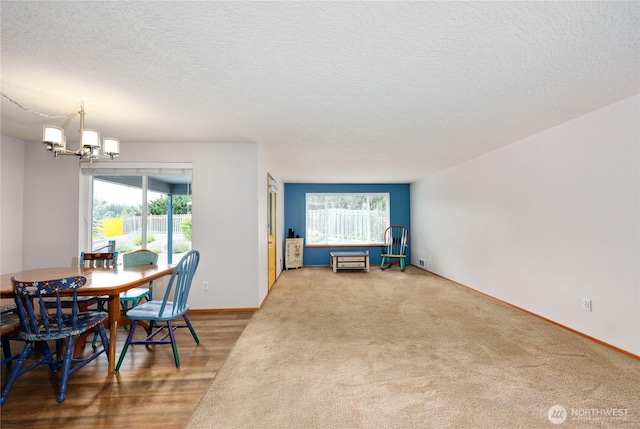 541 Salal Pl, Sequim, WA 98382 - dining room featuring a chandelier, healthy amount of natural light, a textured ceiling, and carpet