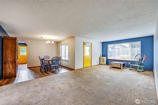541 Salal Pl, Sequim, WA 98382 - living area with a chandelier, carpet, wood finished floors, and a textured ceiling