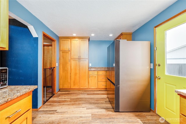 541 Salal Pl, Sequim, WA 98382 - kitchen with stainless steel appliances, light wood finished floors, recessed lighting, and light stone countertops