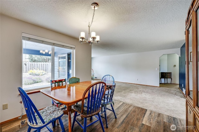 541 Salal Pl, Sequim, WA 98382 - dining area featuring a chandelier, a textured ceiling, and wood finished floors