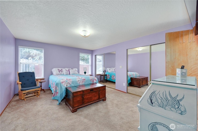 541 Salal Pl, Sequim, WA 98382 - bedroom featuring two closets, carpet floors, and a textured ceiling
