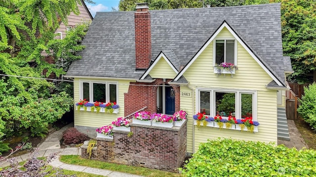 2463 26th Ave E, Seattle, WA 98112 - view of front of house with roof with shingles and a chimney