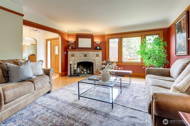2463 26th Ave E, Seattle, WA 98112 - living room with light wood-style floors, arched walkways, and a tile fireplace