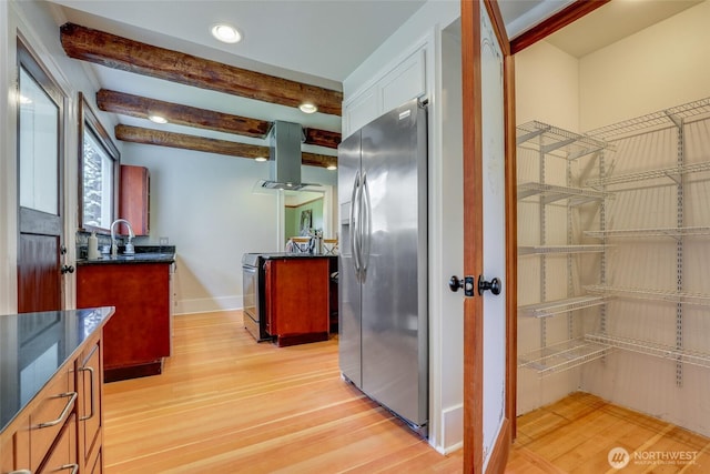 2463 26th Ave E, Seattle, WA 98112 - kitchen with appliances with stainless steel finishes, island range hood, light wood-type flooring, beam ceiling, and recessed lighting