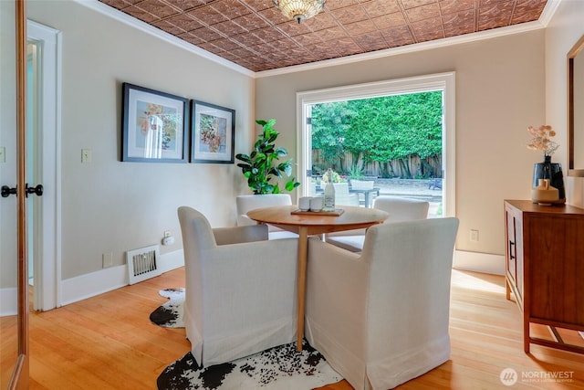 2463 26th Ave E, Seattle, WA 98112 - dining space with crown molding, an ornate ceiling, and wood finished floors