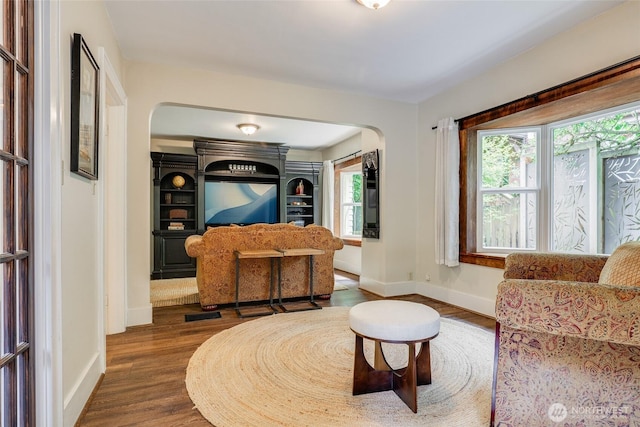 2463 26th Ave E, Seattle, WA 98112 - living area with arched walkways, healthy amount of natural light, and dark wood-style flooring