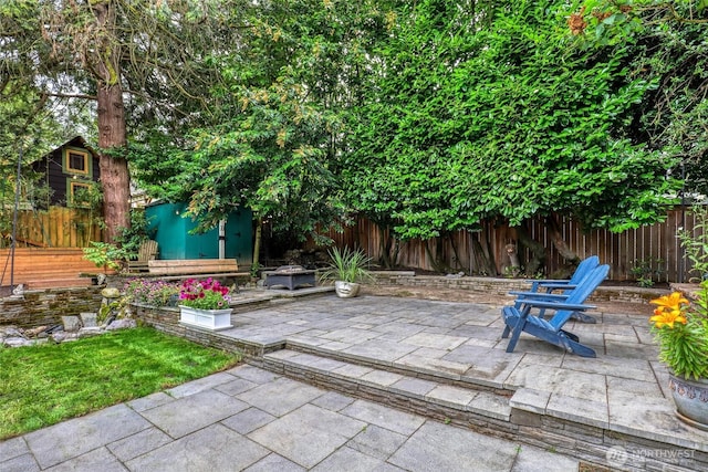 2463 26th Ave E, Seattle, WA 98112 - fenced backyard with a patio and a storage unit