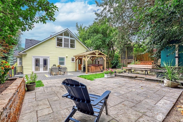 2463 26th Ave E, Seattle, WA 98112 - rear view of house featuring a hot tub, french doors, a patio, a gazebo, and outdoor dining space